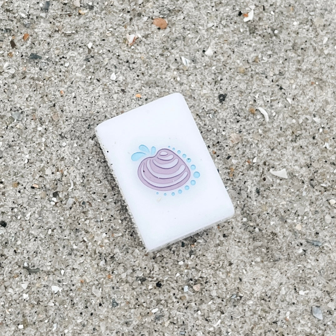 Image of the Pawleys Island Shell Flower tile in the sand