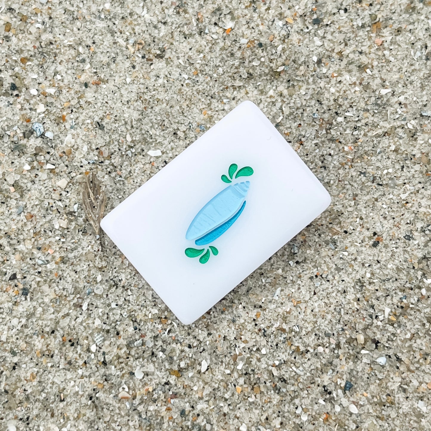 The Lettered Olive Flower tile in the sand
